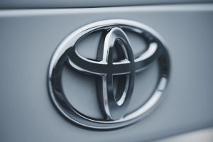 Detailed image of a shiny silver Toyota emblem on a vehicles surface.