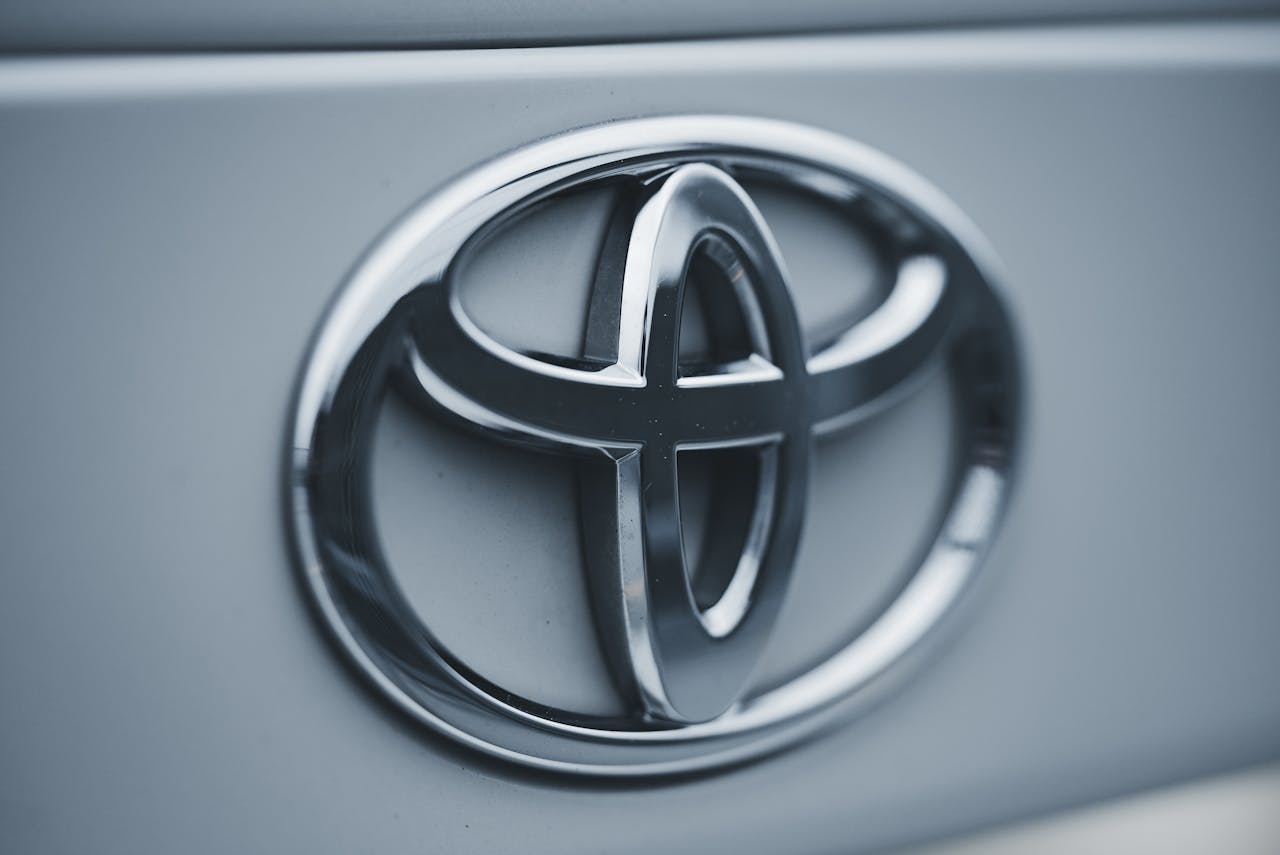 Detailed image of a shiny silver Toyota emblem on a vehicles surface.